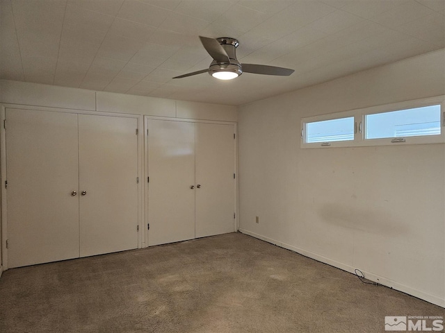 311 S Main St, Yerington, NV 89447 - unfurnished bedroom with two closets, carpet, a ceiling fan, and baseboards