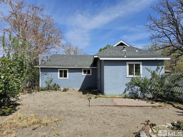 311 S Main St, Yerington, NV 89447 - rear view of house with stucco siding and a shingled roof