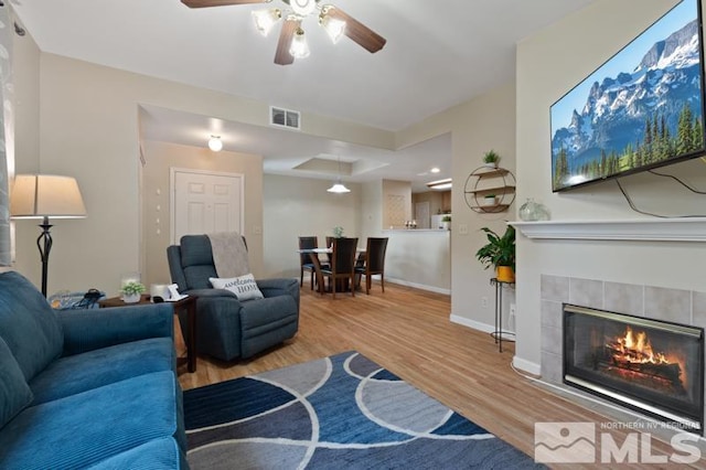 900 S Meadows Pkwy Unit 614, Reno, NV 89521 - living area featuring wood finished floors, a ceiling fan, a fireplace, and baseboards