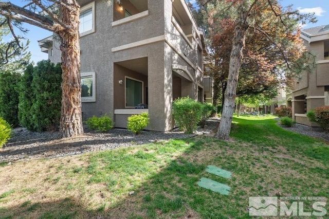 900 S Meadows Pkwy Unit 614, Reno, NV 89521 - view of property exterior with a yard and stucco siding