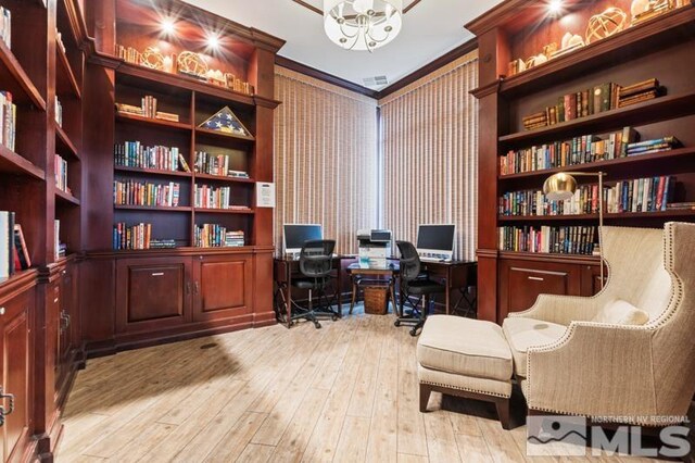 900 S Meadows Pkwy Unit 614, Reno, NV 89521 - home office with wall of books, wood-type flooring, a chandelier, and crown molding