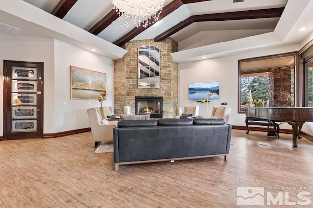 900 S Meadows Pkwy Unit 614, Reno, NV 89521 - living area with beam ceiling, baseboards, a fireplace, light wood finished floors, and a chandelier