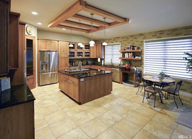 2057 W Washington St, Carson City, NV 89703 - kitchen featuring stainless steel appliances, a tray ceiling, a kitchen island with sink, recessed lighting, and decorative light fixtures