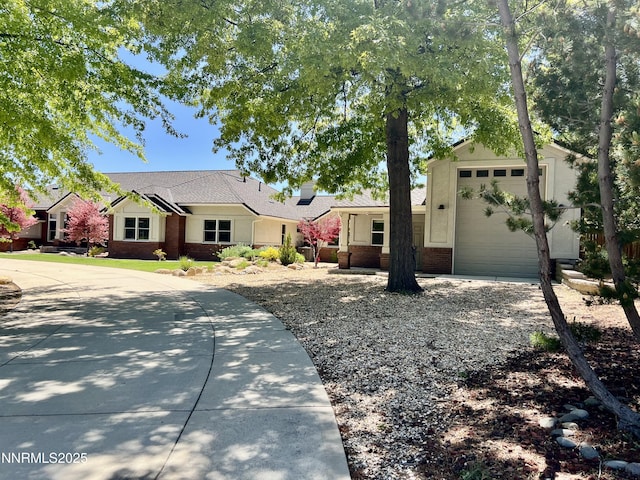 2057 W Washington St, Carson City, NV 89703 - view of front of property with brick siding, a garage, and concrete driveway