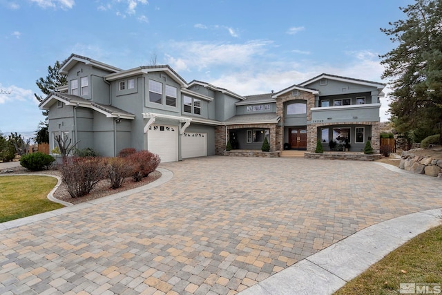 14245 Prairie Flower Ct, Reno, NV 89511 - townhome / multi-family property with an attached garage, stone siding, decorative driveway, and stucco siding