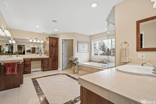 14245 Prairie Flower Ct, Reno, NV 89511 - bathroom with a bath, two vanities, recessed lighting, and a stall shower