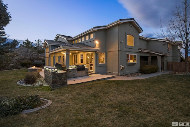 14245 Prairie Flower Ct, Reno, NV 89511 - back of house with area for grilling, a patio area, a fire pit, and stucco siding