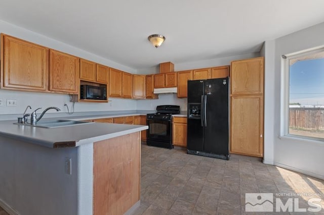 95 Hunter Park Way, Fallon, NV 89406 - kitchen with black appliances, a sink, a peninsula, under cabinet range hood, and light countertops