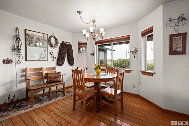 6811 Reno Hwy, Fallon, NV 89406 - dining room featuring a chandelier, hardwood / wood-style flooring, and baseboards