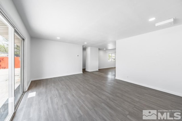 2441 Baxter, Sparks, NV 89431 - unfurnished living room featuring healthy amount of natural light, recessed lighting, dark wood-style flooring, and baseboards