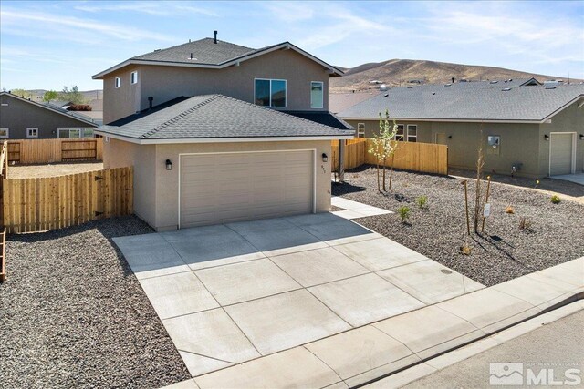 887 Agate, Fernley, NV 89408 - view of front of home with stucco siding, a shingled roof, driveway, and an attached garage