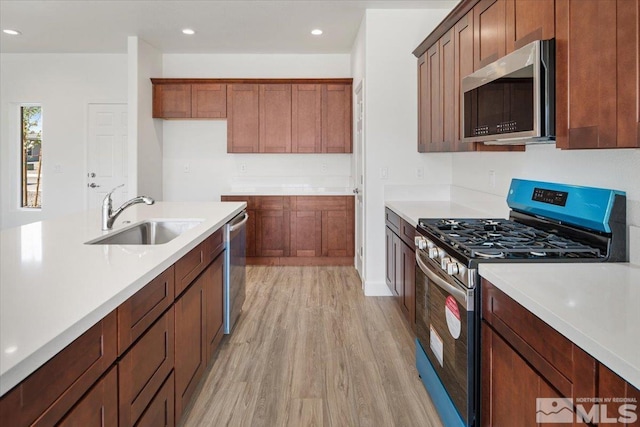 887 Agate, Fernley, NV 89408 - kitchen featuring appliances with stainless steel finishes, a sink, light wood-style floors, light countertops, and recessed lighting