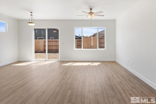 887 Agate, Fernley, NV 89408 - spare room featuring a ceiling fan, wood finished floors, and baseboards