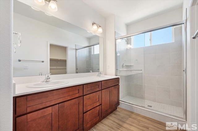 887 Agate, Fernley, NV 89408 - bathroom with a shower stall, double vanity, wood finished floors, and a walk in closet