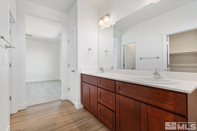 887 Agate, Fernley, NV 89408 - full bathroom featuring wood finished floors, double vanity, a spacious closet, and baseboards