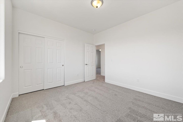 887 Agate, Fernley, NV 89408 - unfurnished bedroom with carpet, baseboards, and a closet