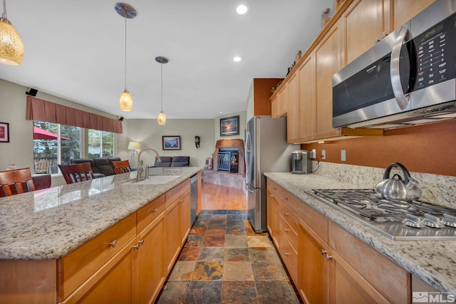 3463 White Mountain Ct, Reno, NV 89511 - kitchen with stainless steel appliances, a sink, stone tile flooring, recessed lighting, and open floor plan