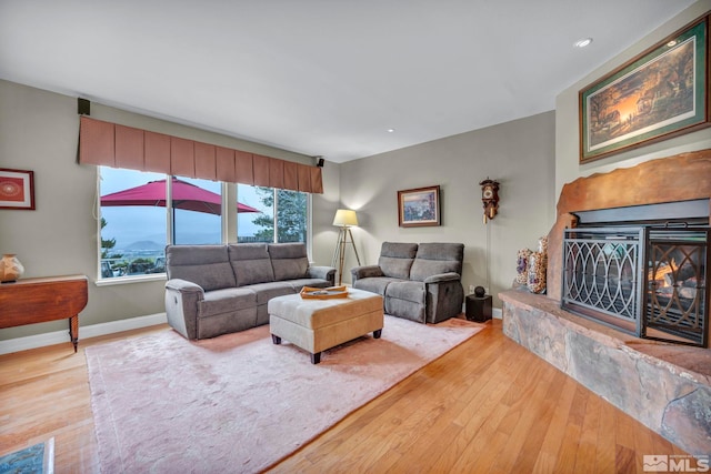 3463 White Mountain Ct, Reno, NV 89511 - living room with hardwood / wood-style floors, a glass covered fireplace, baseboards, and recessed lighting