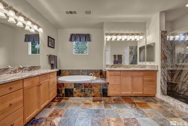 3463 White Mountain Ct, Reno, NV 89511 - bathroom featuring stone tile flooring, two vanities, a tile shower, and a bath