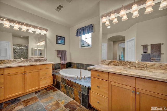 3463 White Mountain Ct, Reno, NV 89511 - bathroom with stone tile flooring, a stall shower, two vanities, and a bath