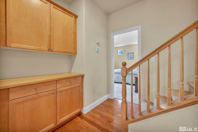3463 White Mountain Ct, Reno, NV 89511 - corridor with light wood-style floors, stairs, and baseboards