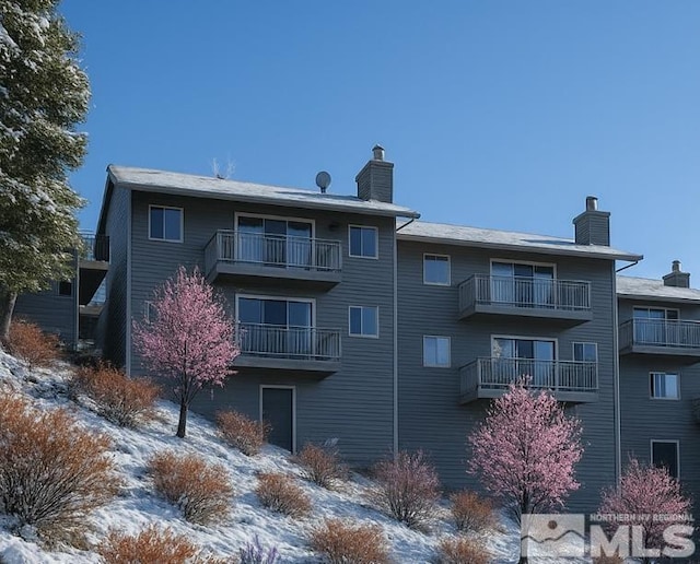 1308 Cave Rock Dr Unit C, Glenbrook, NV 89413 - snow covered house featuring a chimney and a balcony