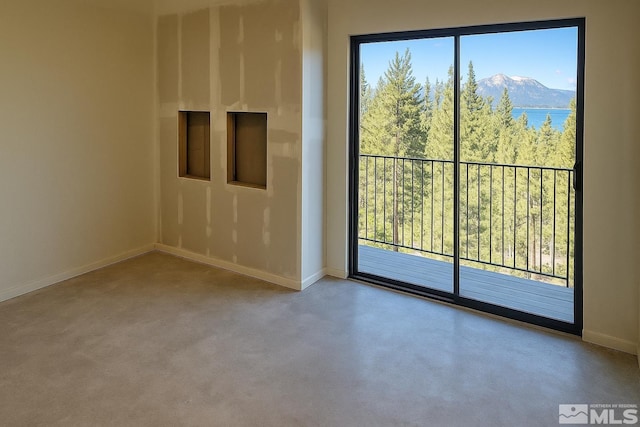 1308 Cave Rock Dr Unit C, Glenbrook, NV 89413 - spare room featuring baseboards, a mountain view, and concrete floors
