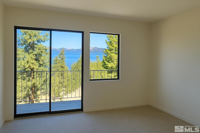 1308 Cave Rock Dr Unit C, Glenbrook, NV 89413 - unfurnished room featuring healthy amount of natural light, a mountain view, and baseboards