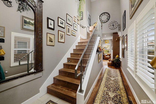 958 Marble Hills Cir, Sparks, NV 89436 - stairs with baseboards, a high ceiling, and arched walkways