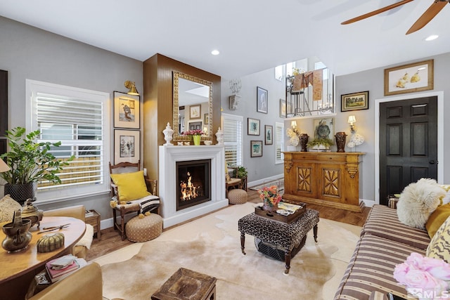 958 Marble Hills Cir, Sparks, NV 89436 - living room with ceiling fan, baseboards, wood finished floors, a warm lit fireplace, and recessed lighting