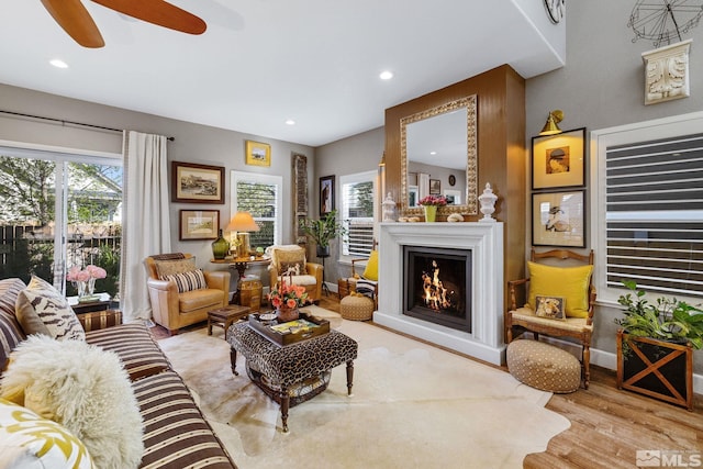 958 Marble Hills Cir, Sparks, NV 89436 - living area with wood finished floors, a lit fireplace, recessed lighting, a ceiling fan, and baseboards