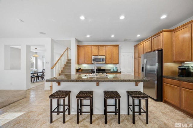 7150 Provence Cir, Reno, NV 89523 - kitchen with appliances with stainless steel finishes, a sink, tile countertops, brown cabinets, and recessed lighting