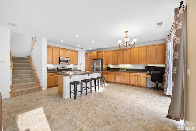7150 Provence Cir, Reno, NV 89523 - kitchen with stainless steel appliances, a kitchen breakfast bar, a sink, a chandelier, and an office area