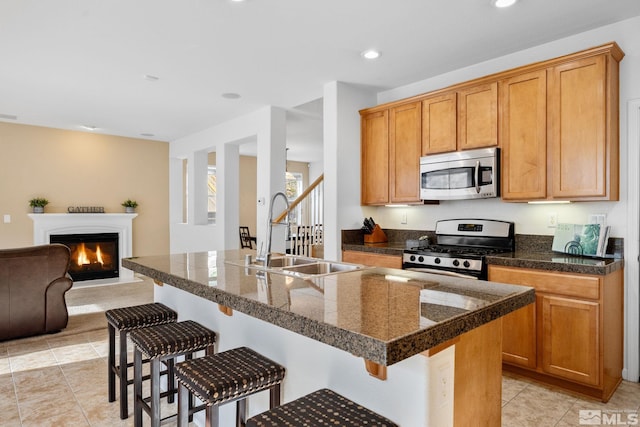 7150 Provence Cir, Reno, NV 89523 - kitchen with appliances with stainless steel finishes, tile countertops, a sink, a breakfast bar area, and light tile patterned flooring