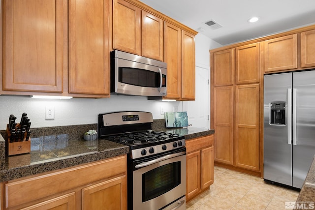 7150 Provence Cir, Reno, NV 89523 - kitchen featuring stainless steel appliances, tile countertops, recessed lighting, light tile patterned flooring, and brown cabinetry