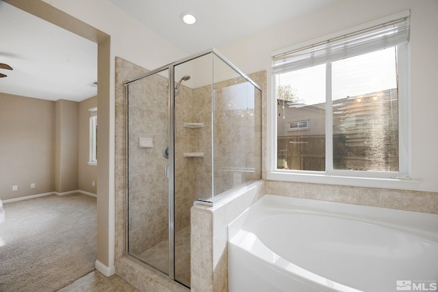 7150 Provence Cir, Reno, NV 89523 - bathroom featuring a shower stall, a garden tub, a ceiling fan, and baseboards