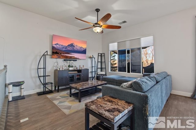 4531 Pyramid Peak Cir, Sparks, NV 89436 - living room with ceiling fan, wood finished floors, baseboards, and a dry bar