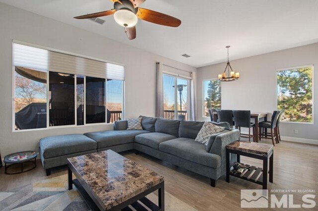 4531 Pyramid Peak Cir, Sparks, NV 89436 - living room featuring a chandelier, light wood-style flooring, healthy amount of natural light, and ceiling fan