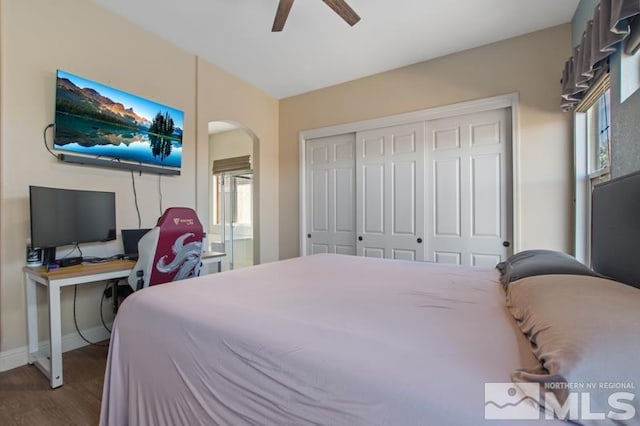4531 Pyramid Peak Cir, Sparks, NV 89436 - bedroom with arched walkways, wood finished floors, a closet, baseboards, and a ceiling fan