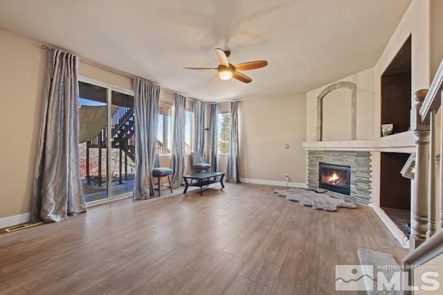 4531 Pyramid Peak Cir, Sparks, NV 89436 - unfurnished living room with a ceiling fan, wood finished floors, baseboards, and a fireplace