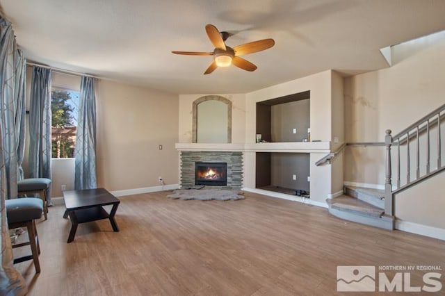 4531 Pyramid Peak Cir, Sparks, NV 89436 - living room featuring baseboards, ceiling fan, stairs, a fireplace, and wood finished floors