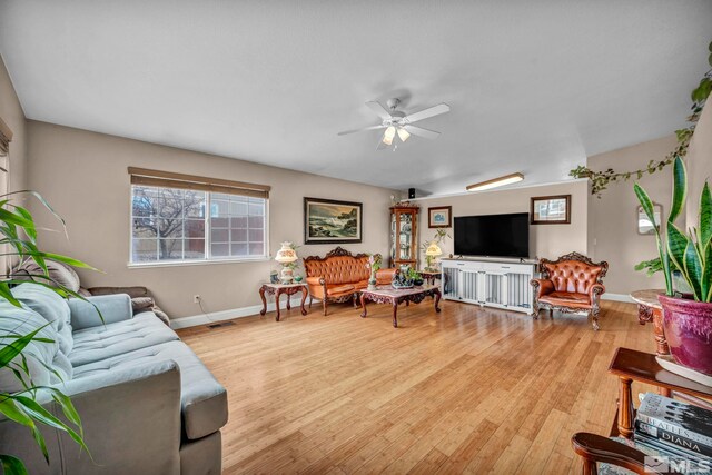 5620 Tassel Dr, Sun Valley, NV 89433 - living area with wood finished floors, ceiling fan, and baseboards