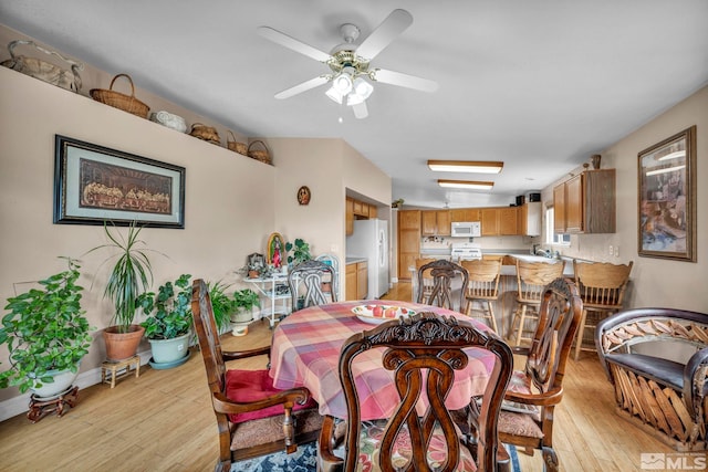 5620 Tassel Dr, Sun Valley, NV 89433 - dining room featuring light wood-style floors, a ceiling fan, and baseboards