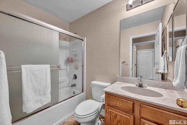 5620 Tassel Dr, Sun Valley, NV 89433 - bathroom with a textured wall, vanity, shower / bath combination with glass door, and toilet