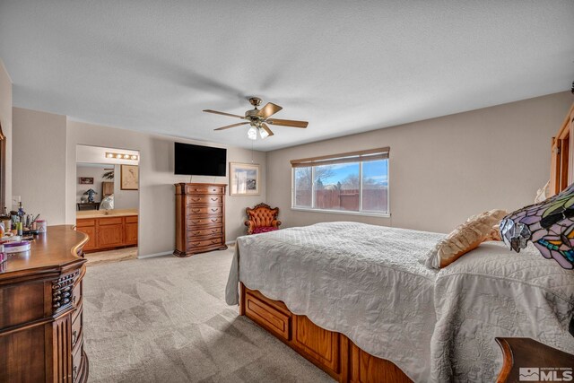 5620 Tassel Dr, Sun Valley, NV 89433 - bedroom with light carpet, ensuite bathroom, and ceiling fan