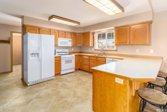 5925 Arvilla Ln, Fallon, NV 89406 - kitchen with white appliances, a sink, a peninsula, light countertops, and a breakfast bar