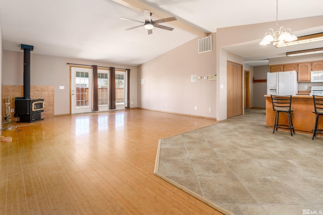 5925 Arvilla Ln, Fallon, NV 89406 - unfurnished living room with ceiling fan, a wood stove, a chandelier, light wood-type flooring, and baseboards