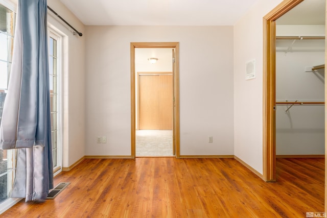 5925 Arvilla Ln, Fallon, NV 89406 - unfurnished bedroom with a walk in closet, light wood-type flooring, baseboards, and a closet