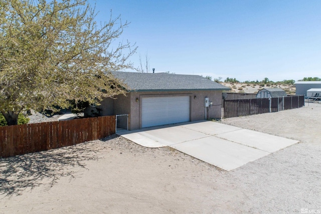5925 Arvilla Ln, Fallon, NV 89406 - garage featuring concrete driveway and fence
