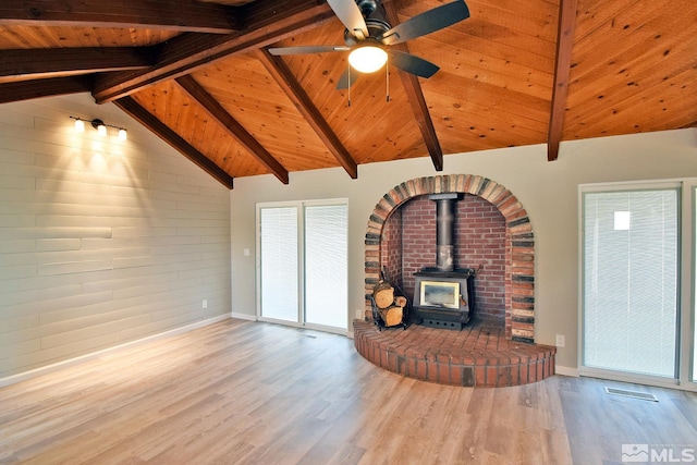 916 Tillman Ln, Gardnerville, NV 89460 - unfurnished living room featuring a wood stove, wood finished floors, wood ceiling, baseboards, and a ceiling fan